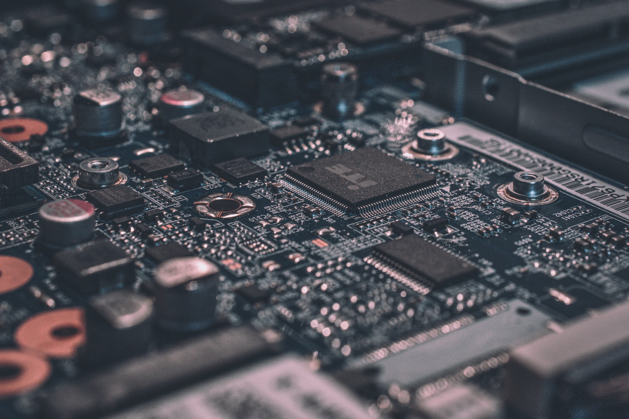 Painel de circuitos eletrônicos em close, com componentes industriais alinhados em grade.